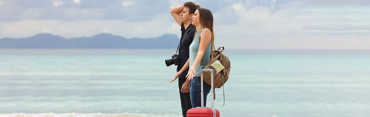 travelers on a beach confused by the weather